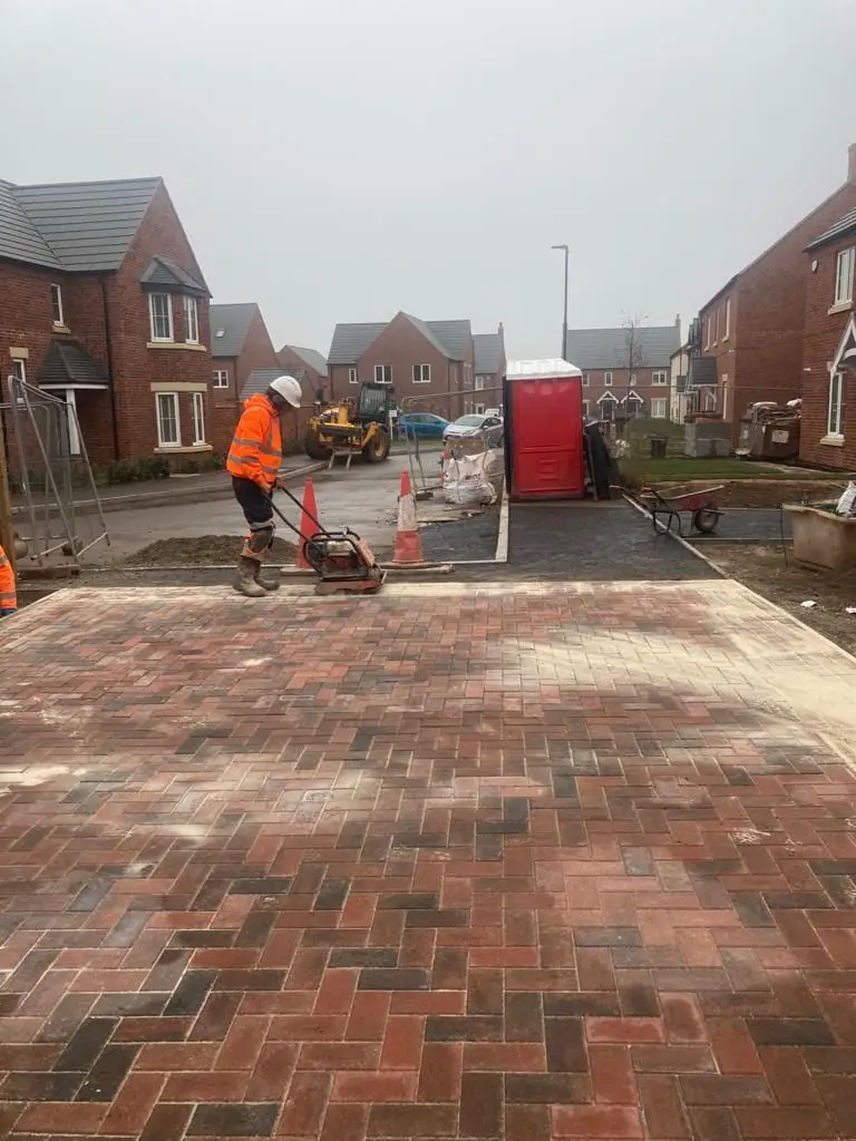 Block paving being compacted on a new housing development