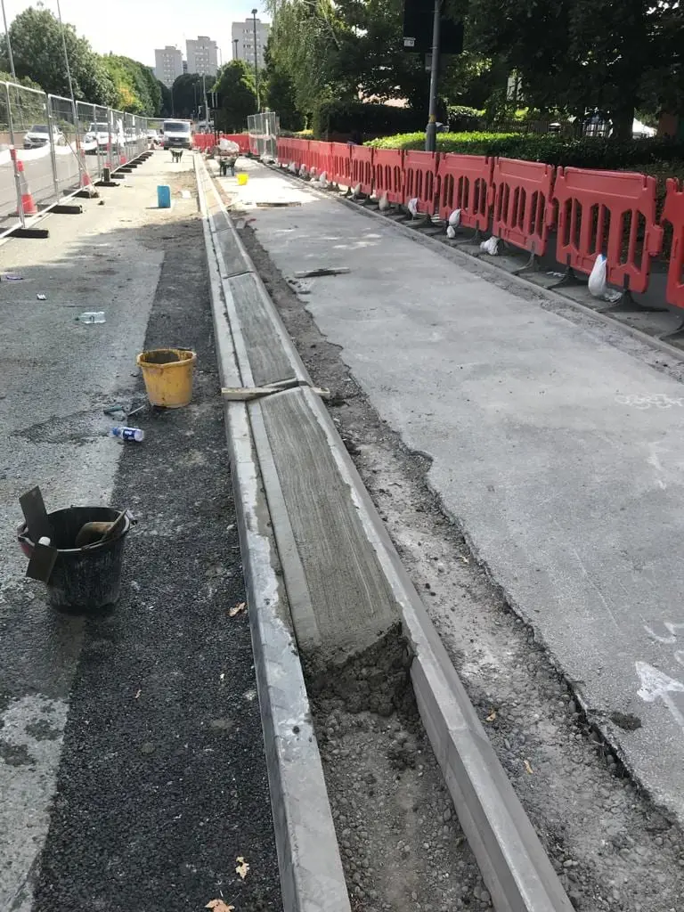 Concrete drainage channel formed alongside a resurfaced road