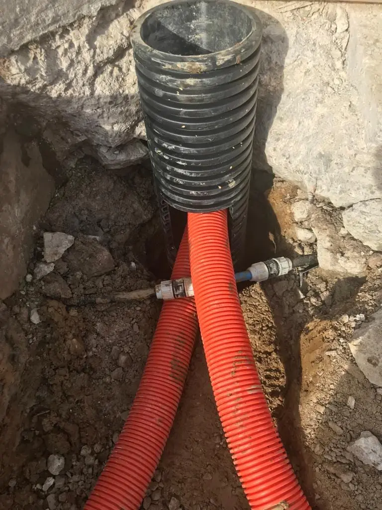 Service ducting installed and bedded in an open trench before backfill